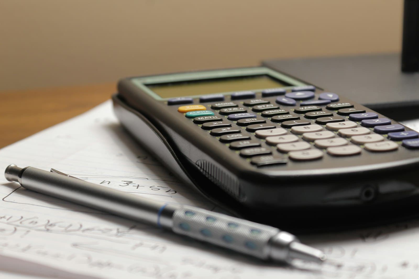 A calculator and pen on a tax form